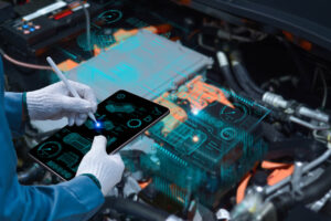 Auto mechanic using a tablet wireless scanning tool to check th